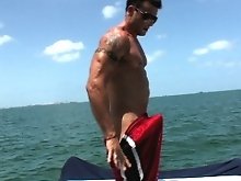 Sexy muscled gay man posing in front of the ocean